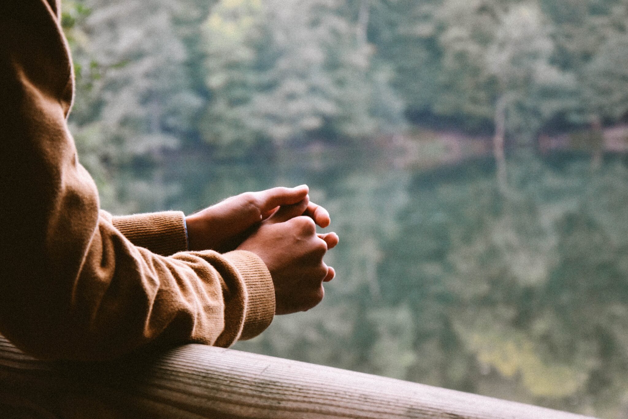 Man prays next to a lake