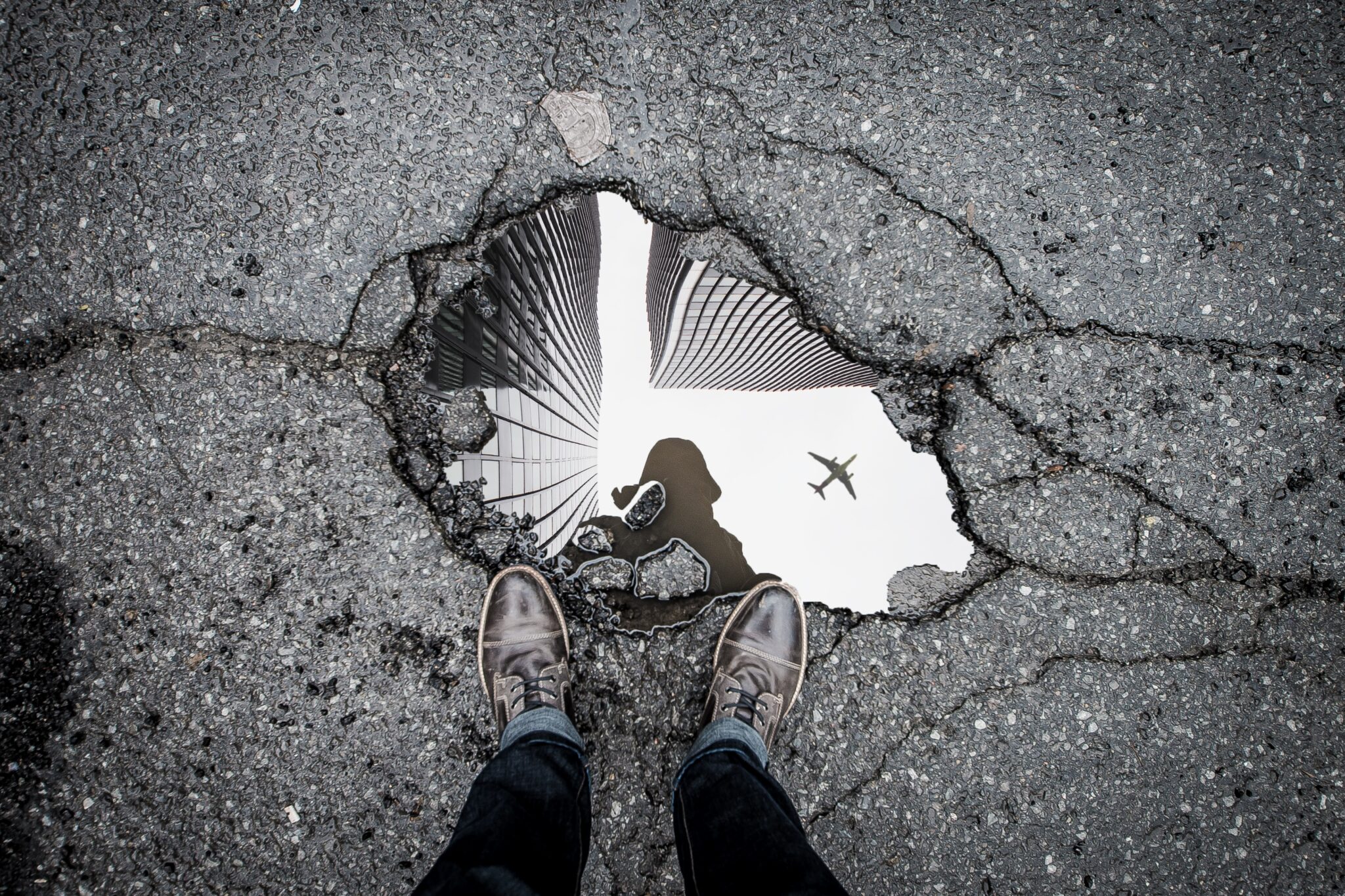 Picture of a person's reflection in a puddle of water