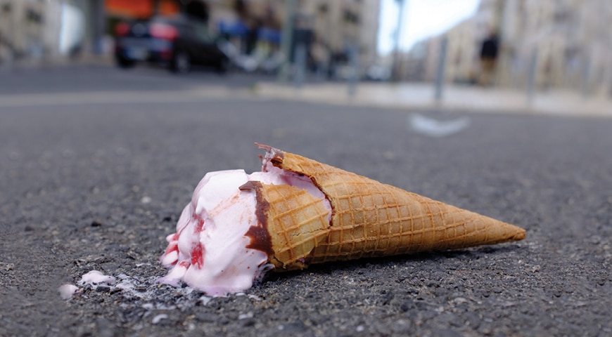 Ice cream cone melting on the ground