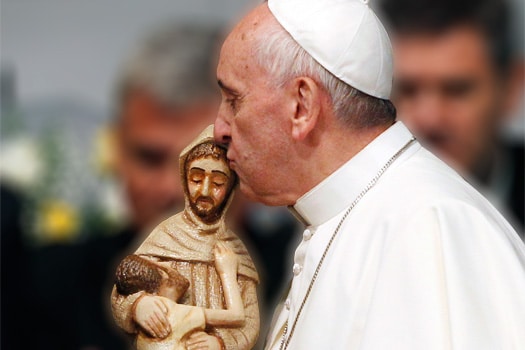 Pope Francis kissing a statue