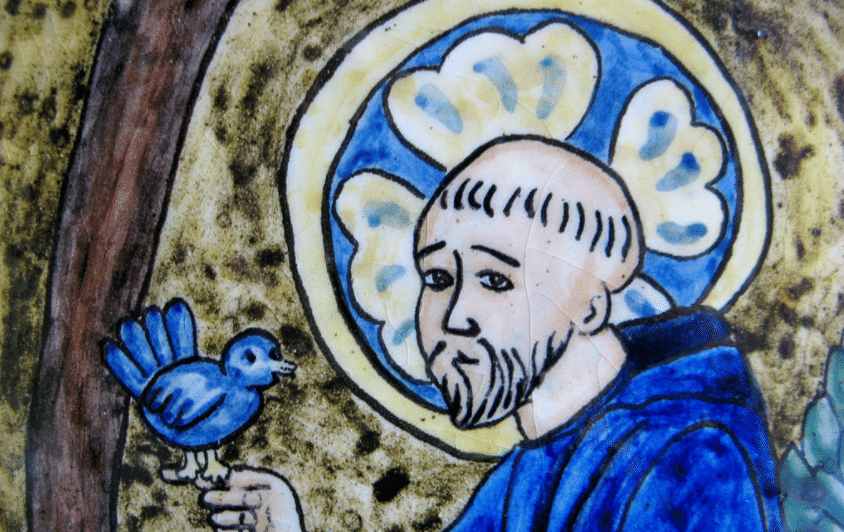 Artwork of Saint Francis with a bird standing on his hand