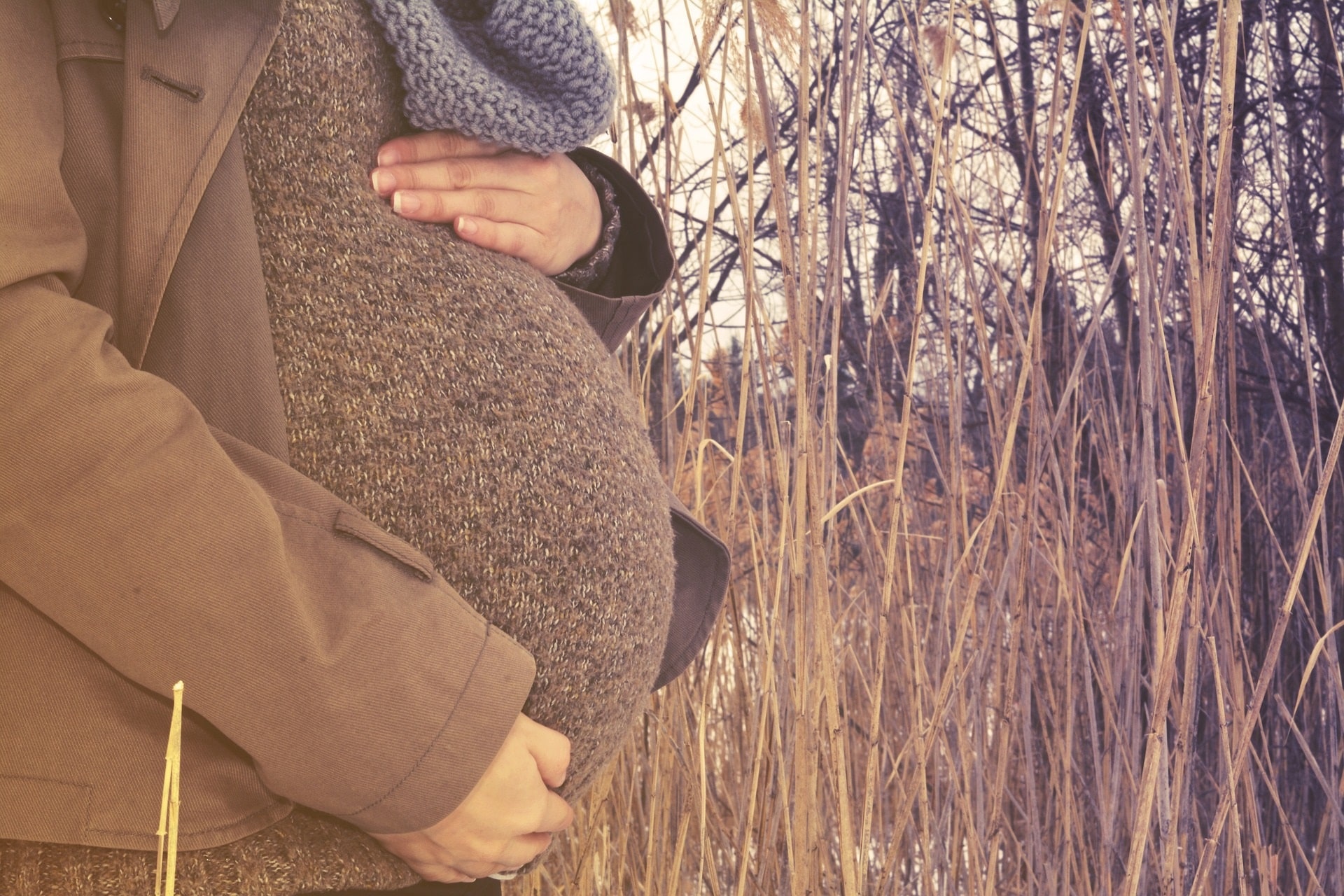 Pregnant woman holding her belly