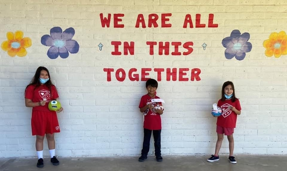 Three kids smiling at Texas Sacred Heart Catholic School