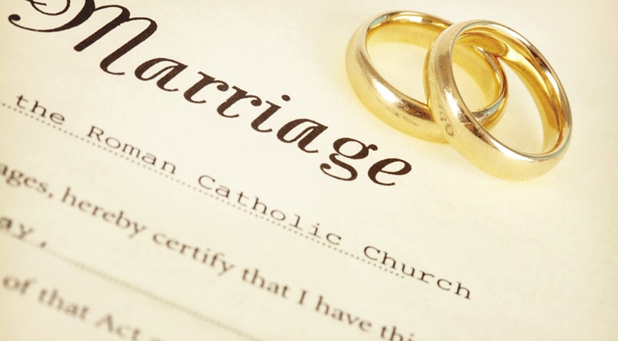 Wedding rings on a marriage certificate