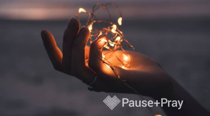 Woman holding a string of lights