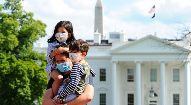 Father and two children all wearing masks