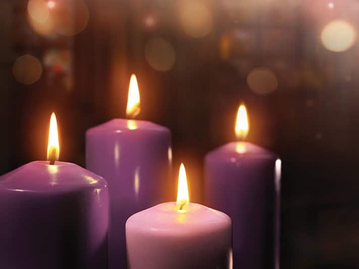 Four purple candles lit on fire