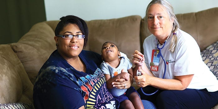 Two people holding a baby