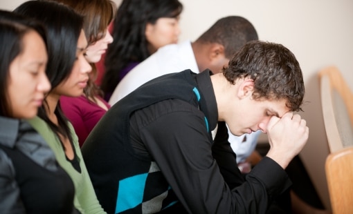 People with eyes closed in church