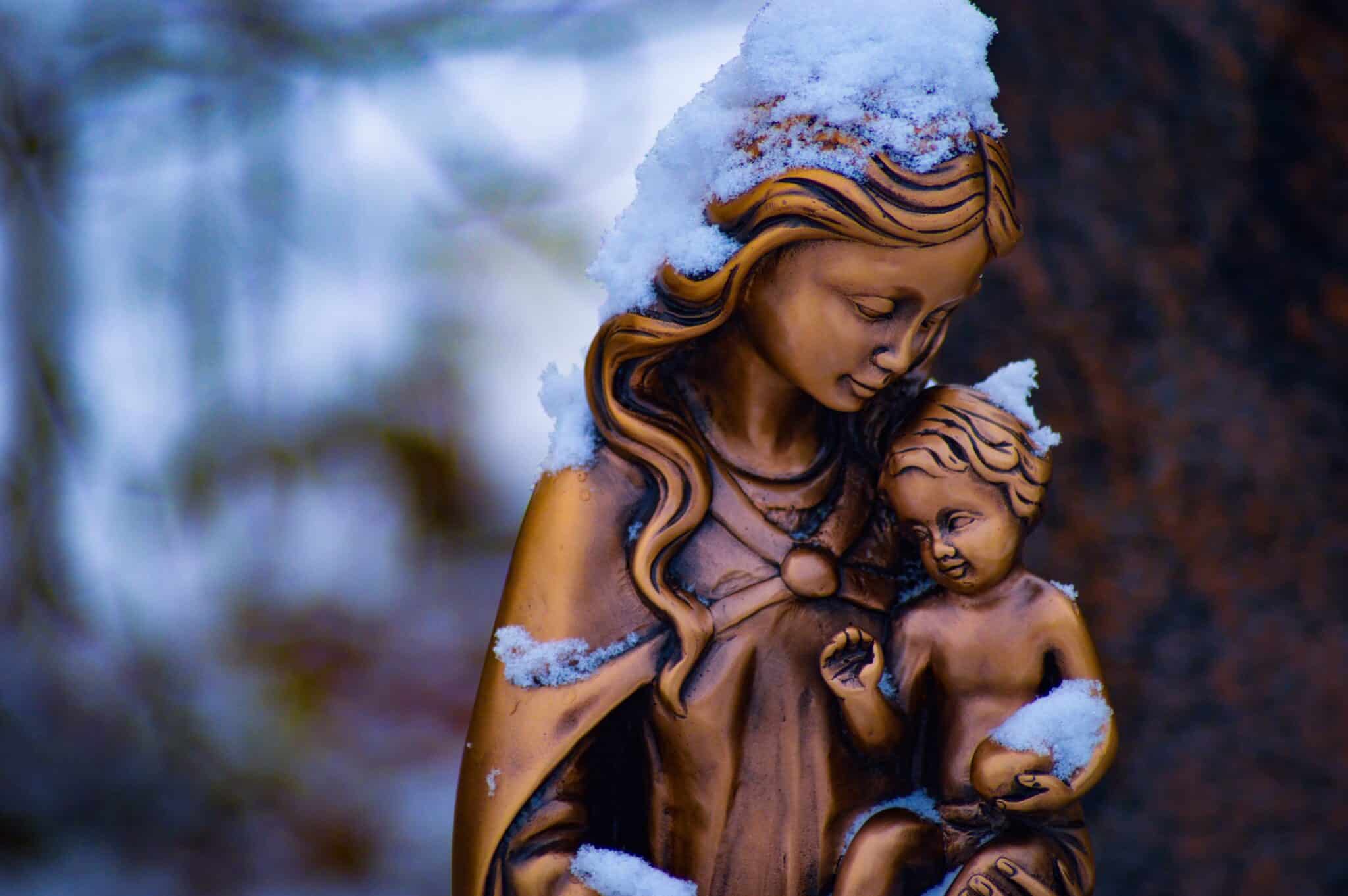 Snow piling up on statues