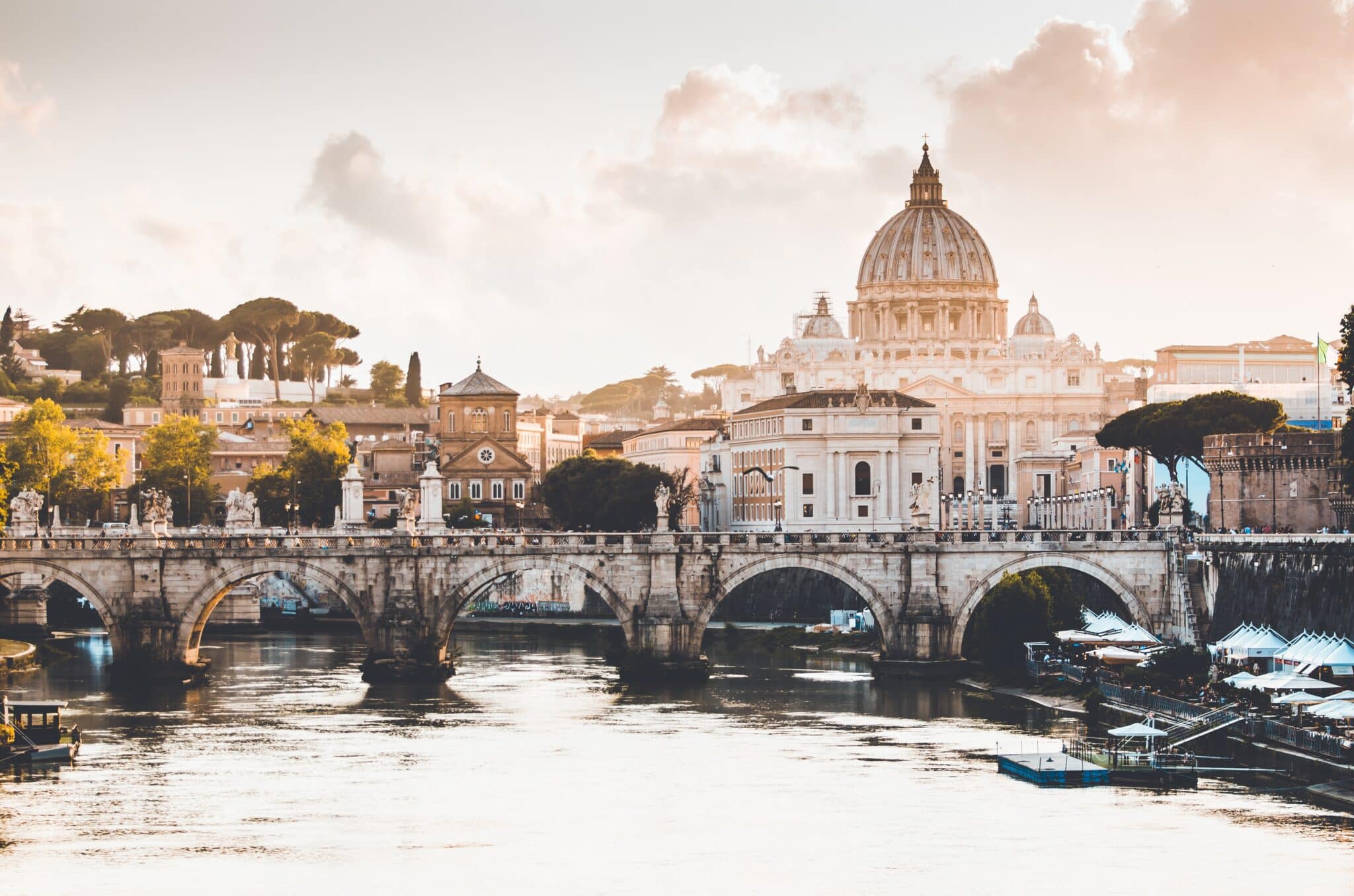 Bridge over water with religious buildings behind it