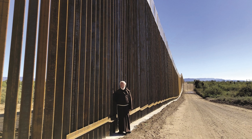 Father Emmit Murphy OFM at the border wall in Arizona