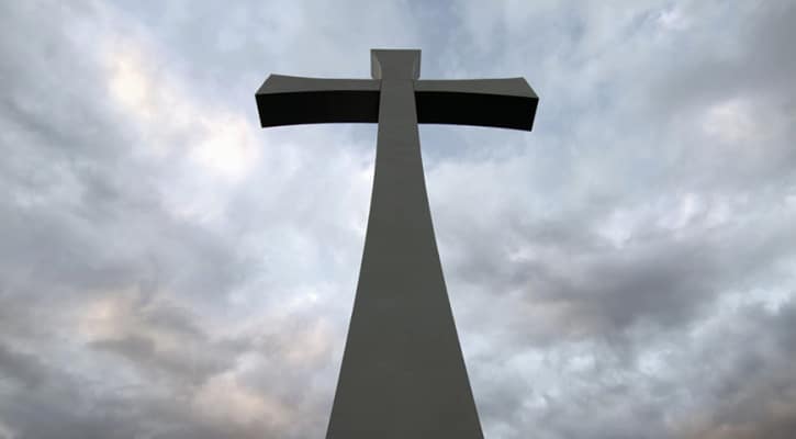Large stone crucifix against a dark sky