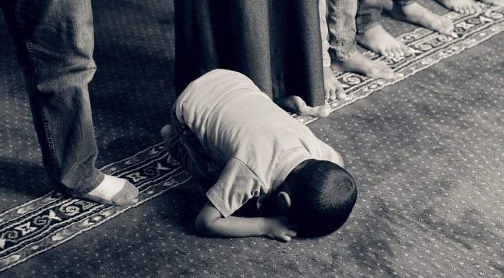 Young Muslim boy praying