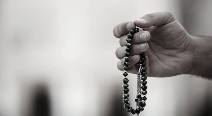 Person holding rosary beads