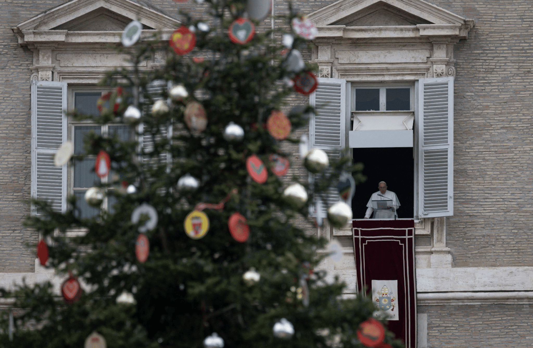 Christmas tree in St. Peter's Square is seen as Pope Francis leads the Angelus