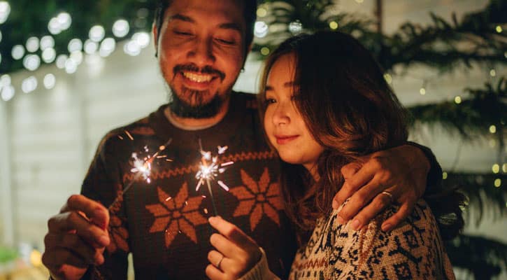 Two people holding sparklers