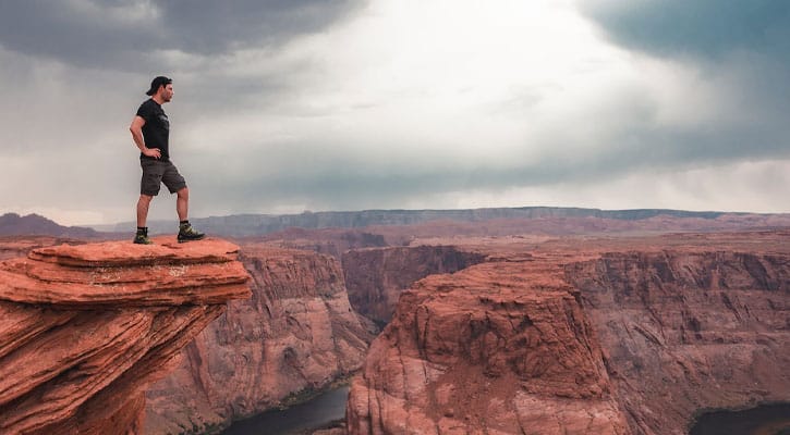 Man standing on canyon rock
