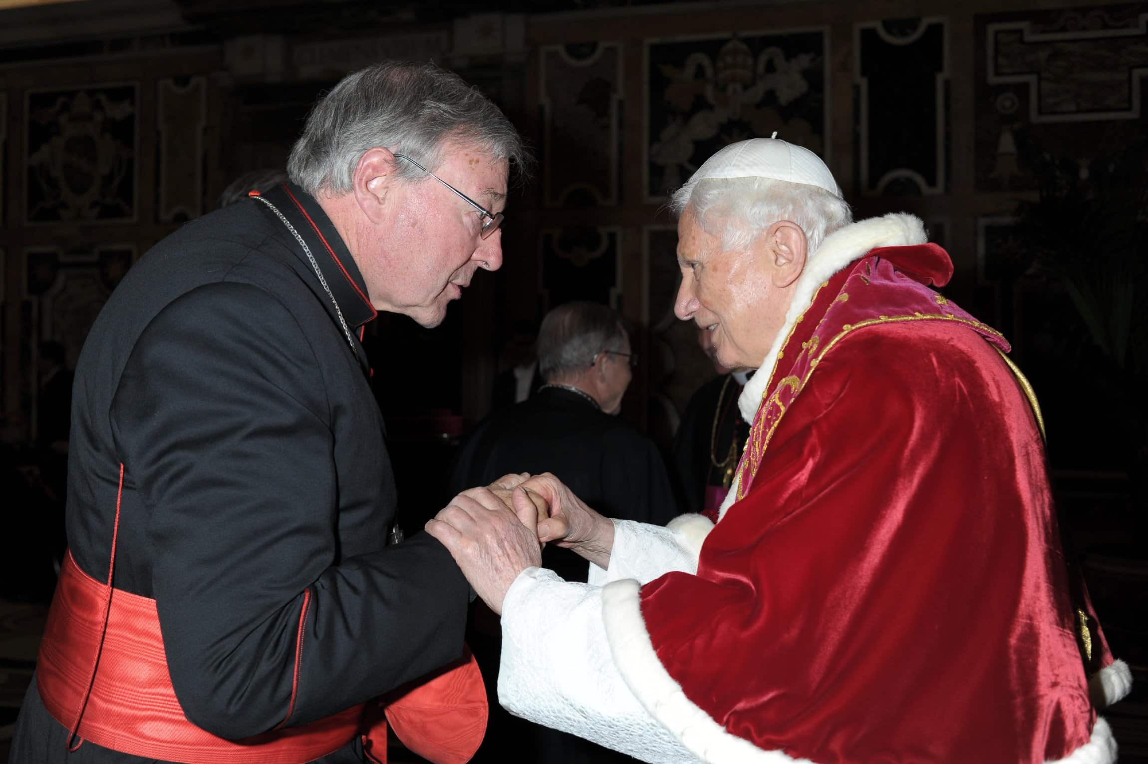 Cardinal George Pell of Sydney exchanges greetings with Pope Benedict XVI as the pope meets for the last time with the College of Cardinals at the Vatican Feb. 28. (CNS photo/L'Osservatore Romano) (March 1, 2013) See POPE-CARDINALS Feb. 28, 2013.