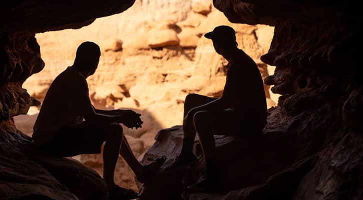 Silhouette of two man in a cavern
