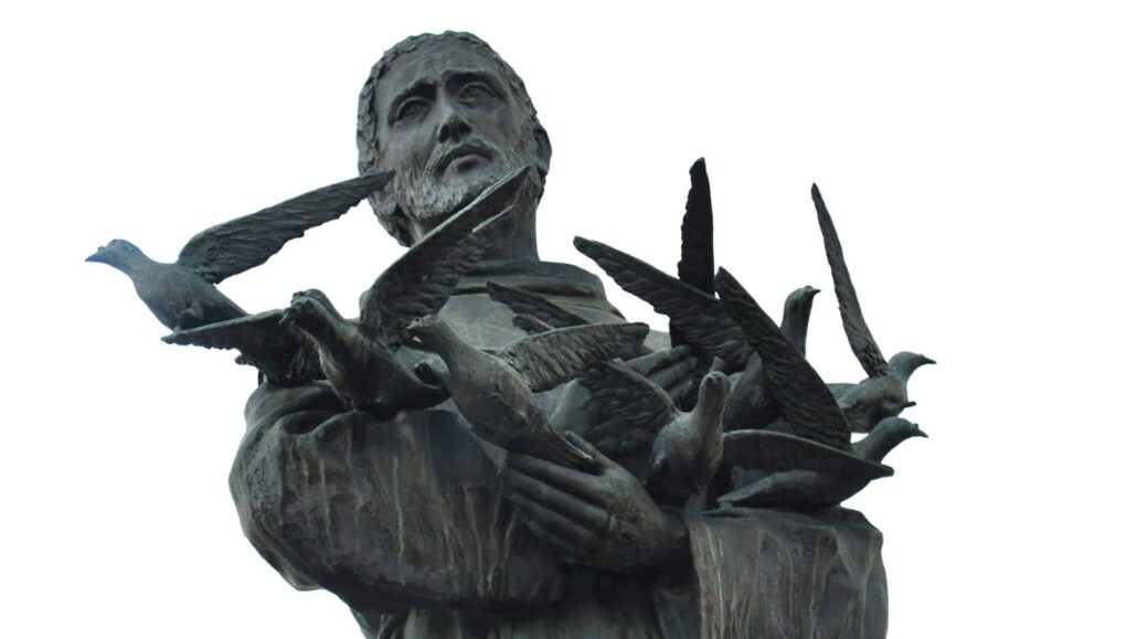 Statue of Saint Francis with birds flying around him