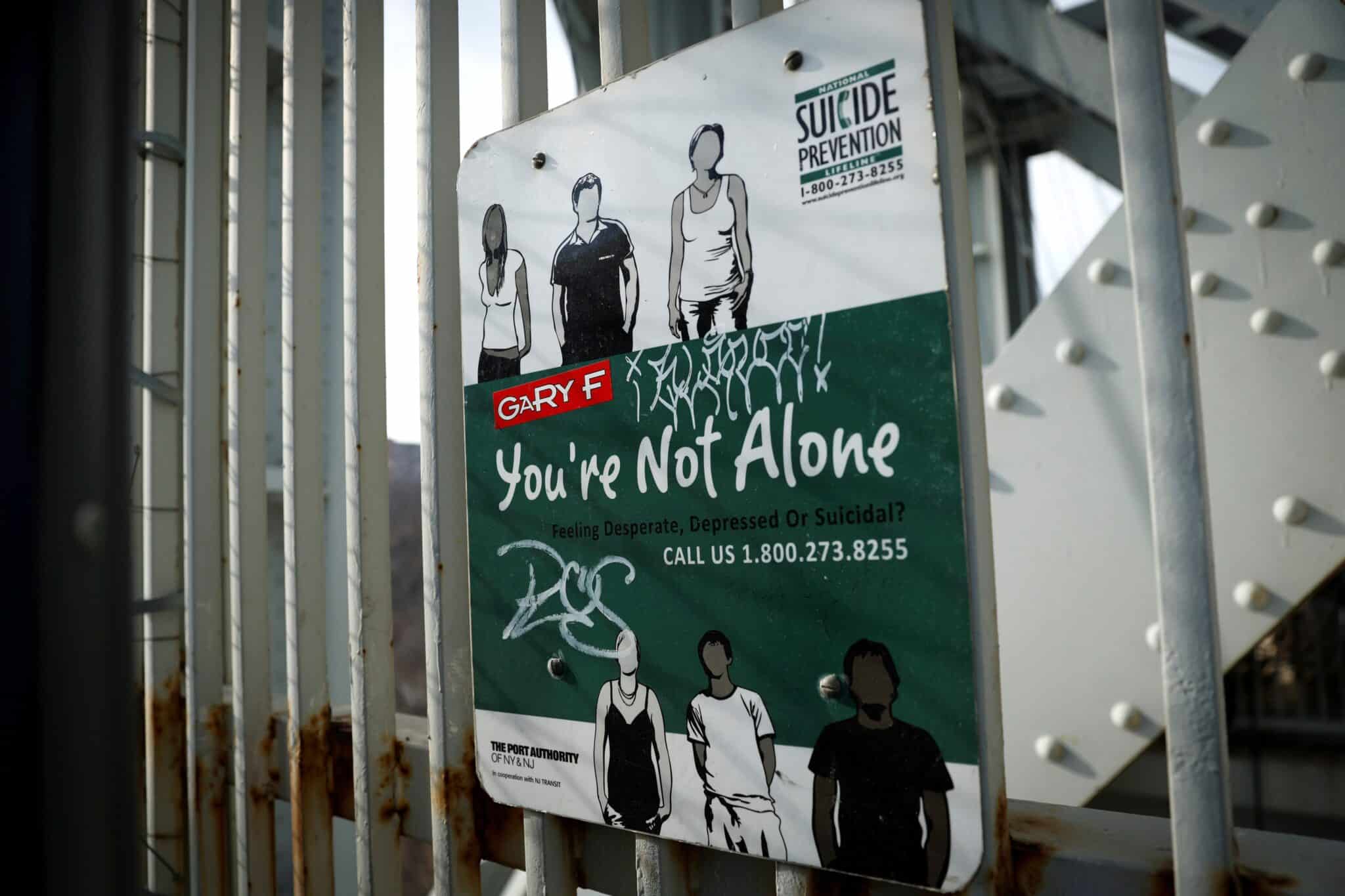 A suicide prevention sign is pictured on a protective fence on the walkway of the George Washington Bridge between in New York City Jan.12, 2022. The suicide epidemic in the U.S. is costing lives, and Catholic dioceses and ministries are racing to get in place much needed accompaniment for those crying for mental health help. (OSV News photo/Mike Segar, Reuters)