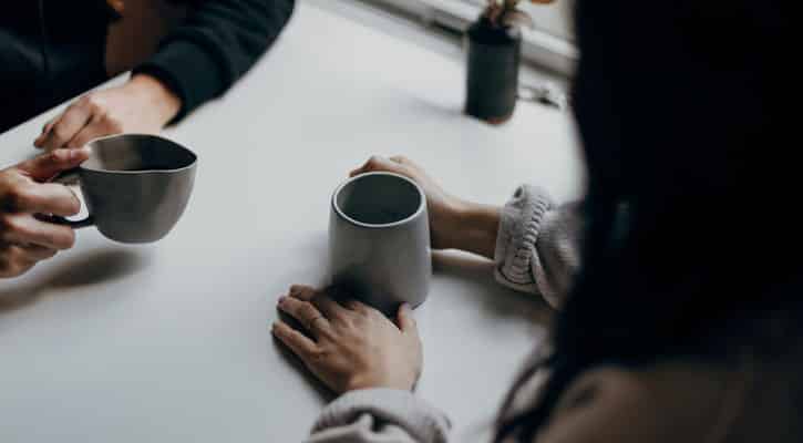 Two people with coffee mugs