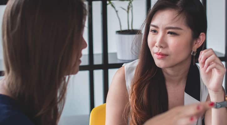 Woman listening to coworker