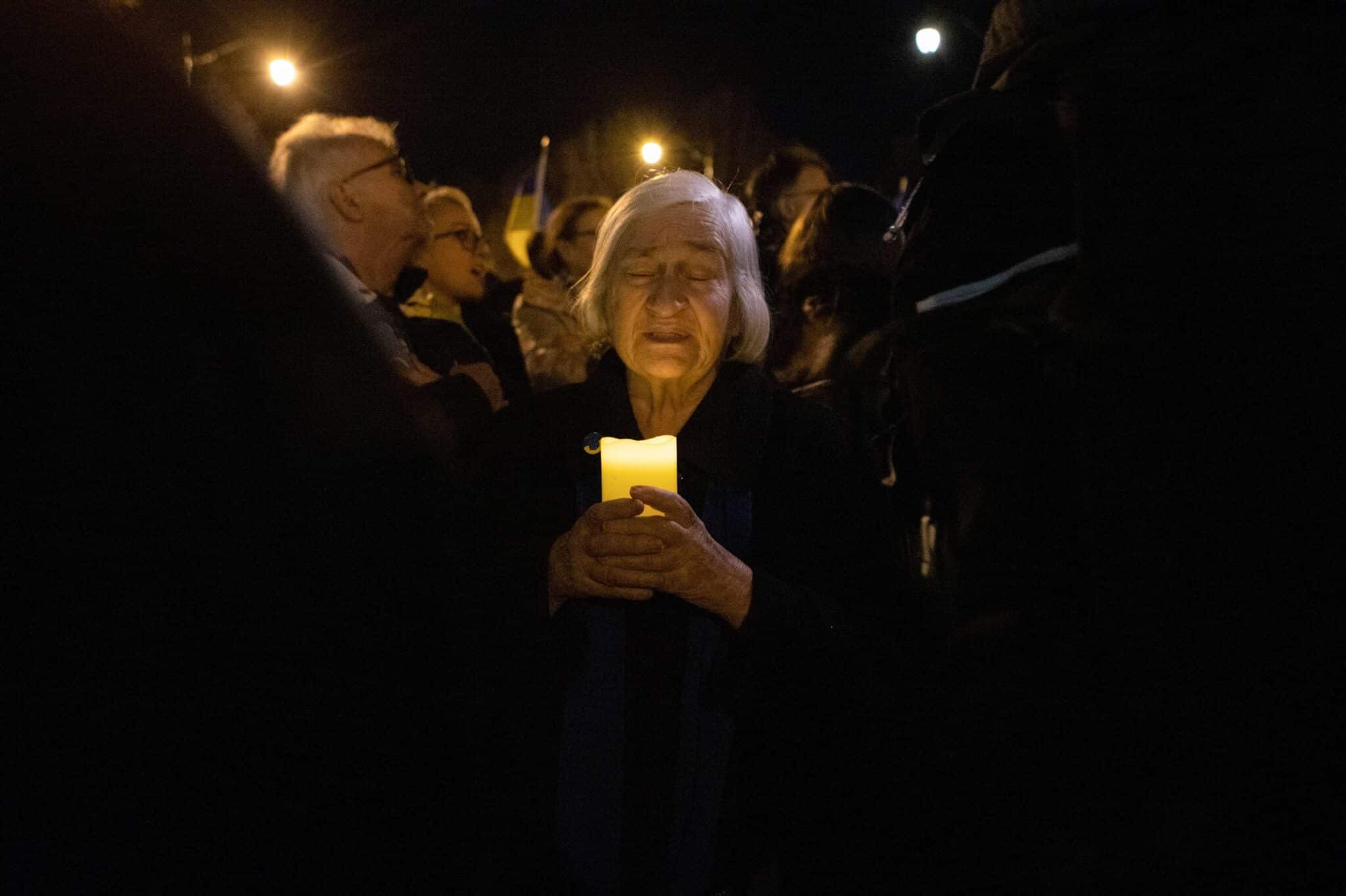 A woman and other members of the Ukrainian community participate in a candlelight vigil in front of the Russian Embassy in Washington Feb. 24, 2023, to mark the first anniversary of Russia's invasion of Ukraine. (OSV News photo/Anna Rose Layden, Reuters)