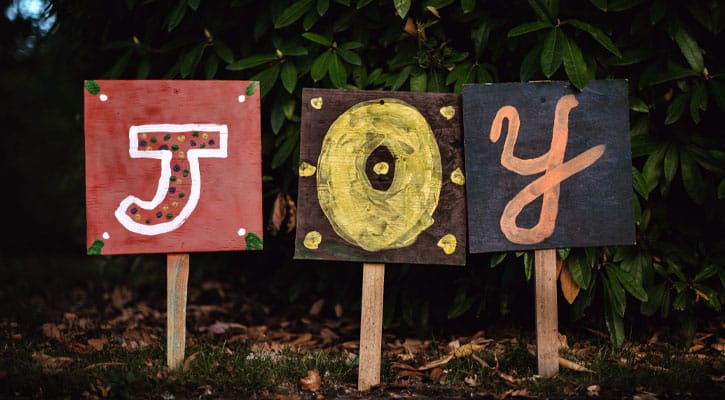 Three signs spelling out the word joy