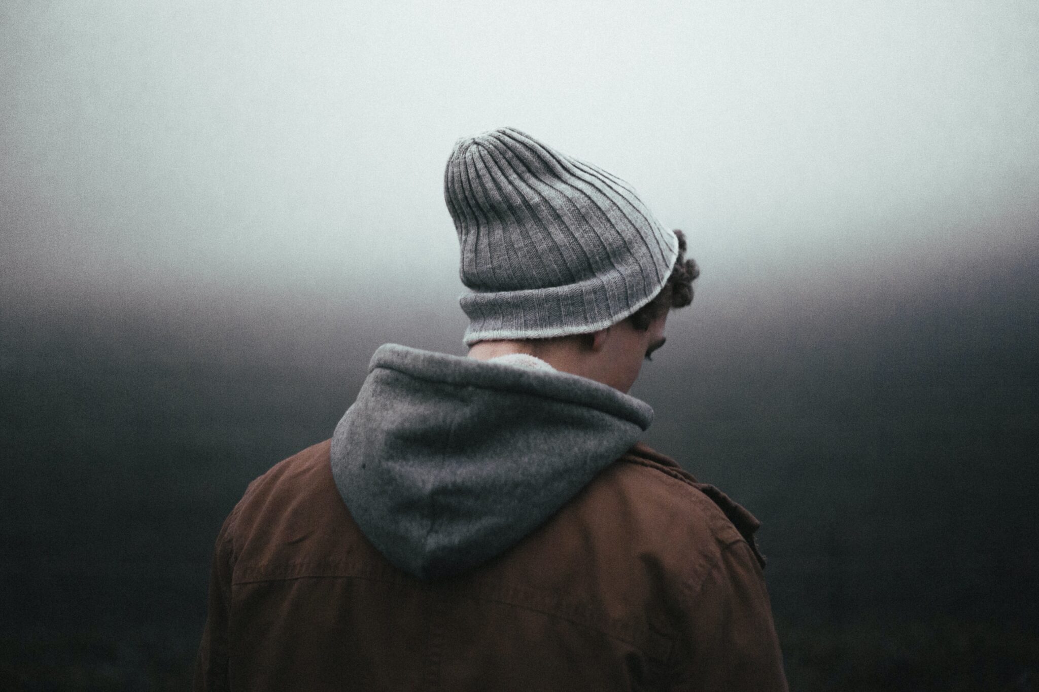 Man looking down | Photo by Andrew Neel on Unsplash