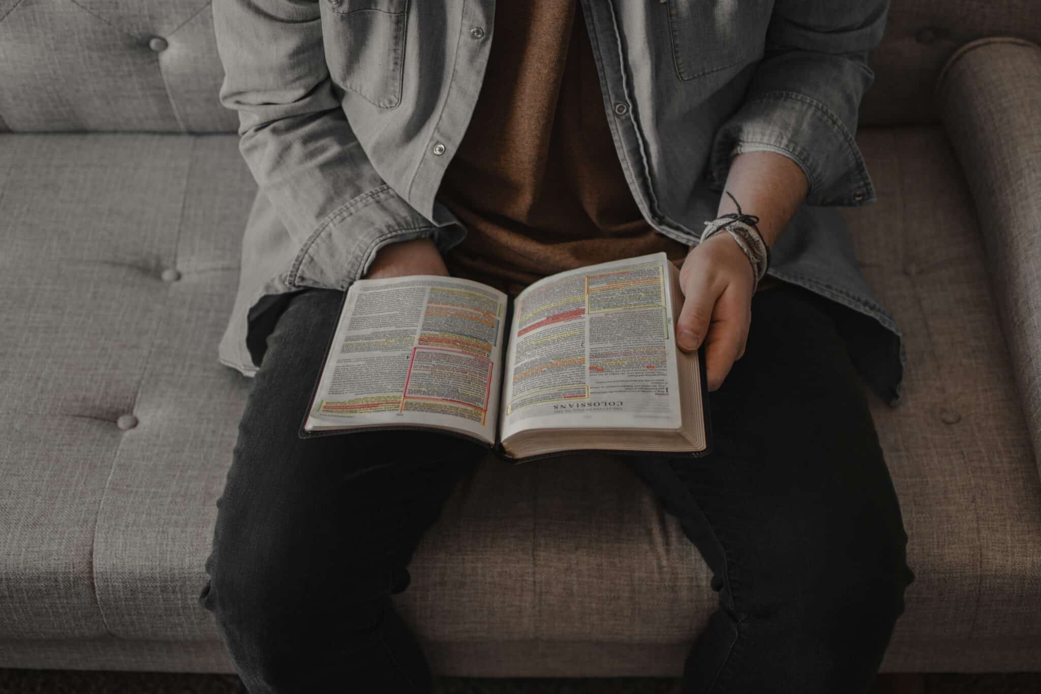 Man reading a bible | Photo by Aaron Owens on Unsplash