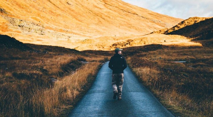 Man walking on a path in the desert