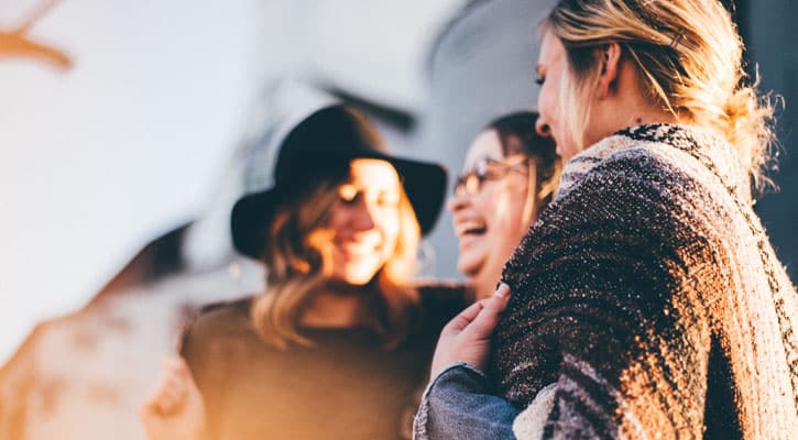 Three women laughing together