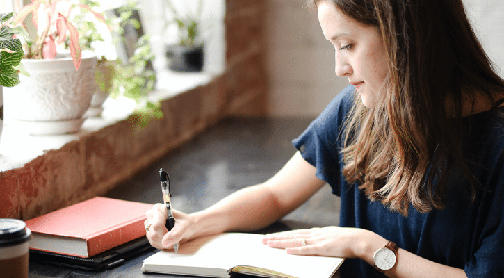 Woman writing in her journal