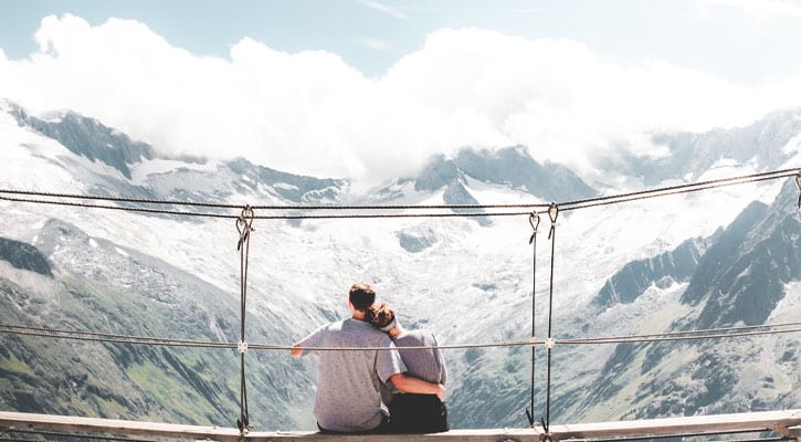 couple hugging on bridge