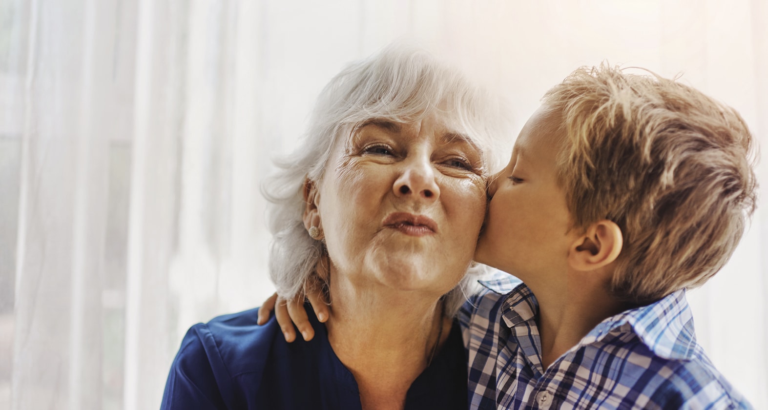 Grandson kissing his grandmother