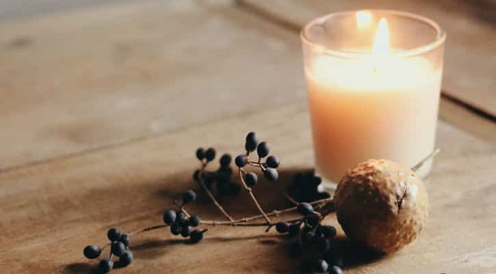 White candle on wood table