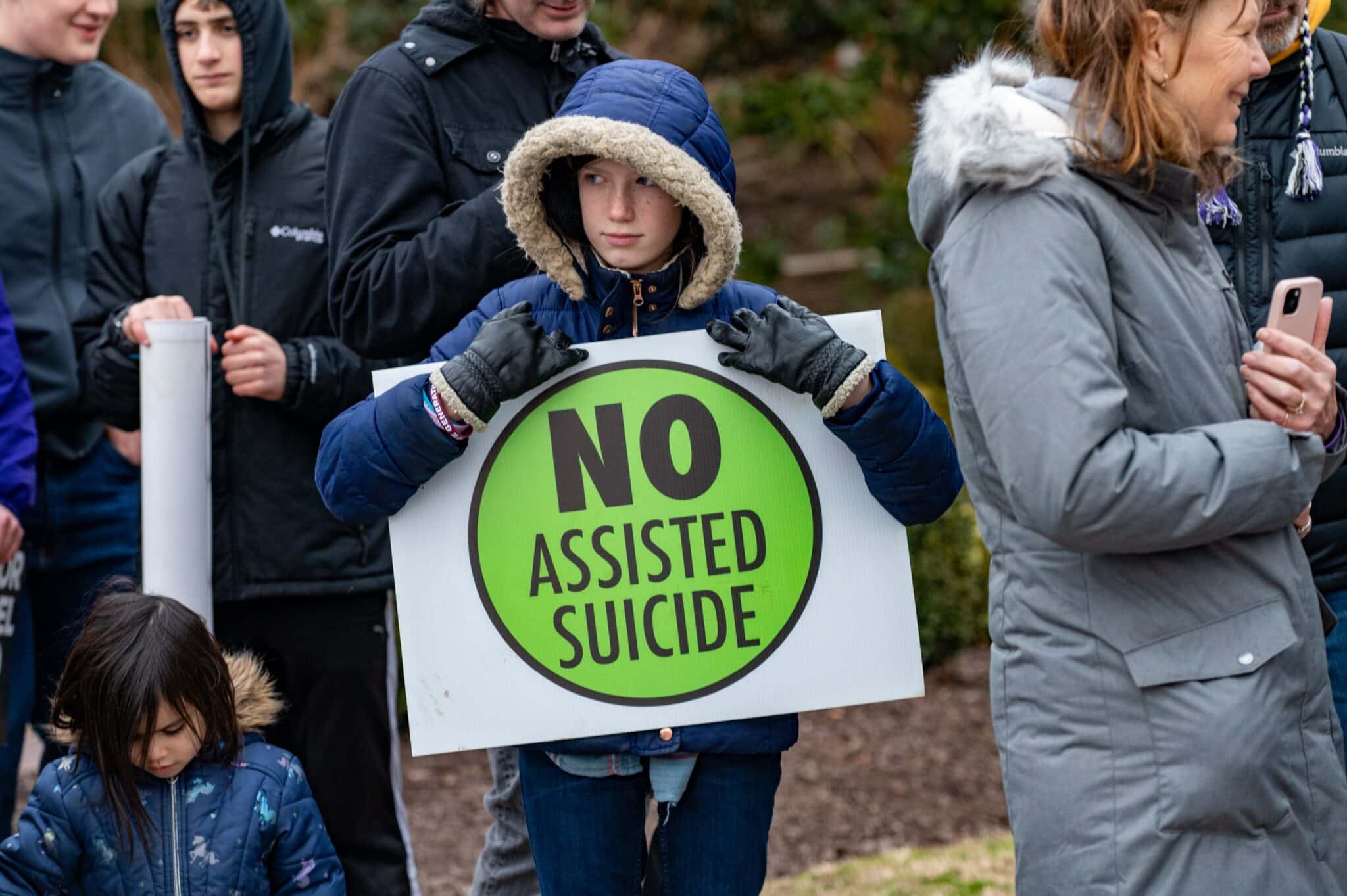 Kateri Oesterle, a 12-year-old parishioner of the St. Agnes and St. William of York pastorate in Baltimore, holds a sign against physician-assisted suicide prior to the start of the 2023 Maryland March for Life rally in Annapolis Feb. 27, 2023. (OSV News photo/Kevin J. Parks, Catholic Review)