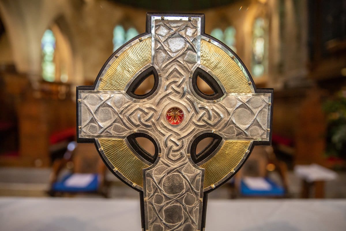 The top of the processional cross that will be used at the coronation of King Charles III in May is seen on the altar of an Anglican parish in Llandudo, Wales, April 19, 2023. Relics of the Christ's cross, a gift from Pope Francis, are under glass in the center of the processional cross. (CNS photo/Dave Custance, courtesy of the Church in Wales)