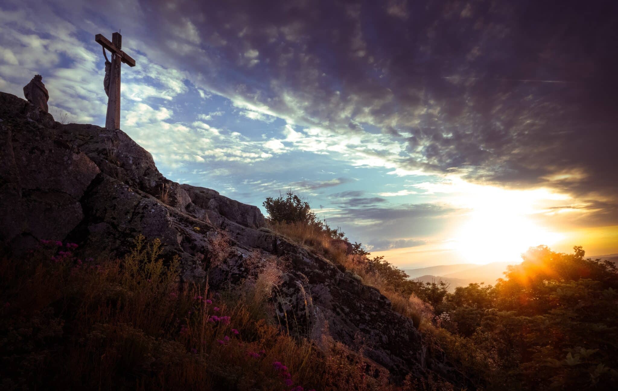 Cross on a mountaintop | Photo by Dimitri Kolpakov on Unsplash