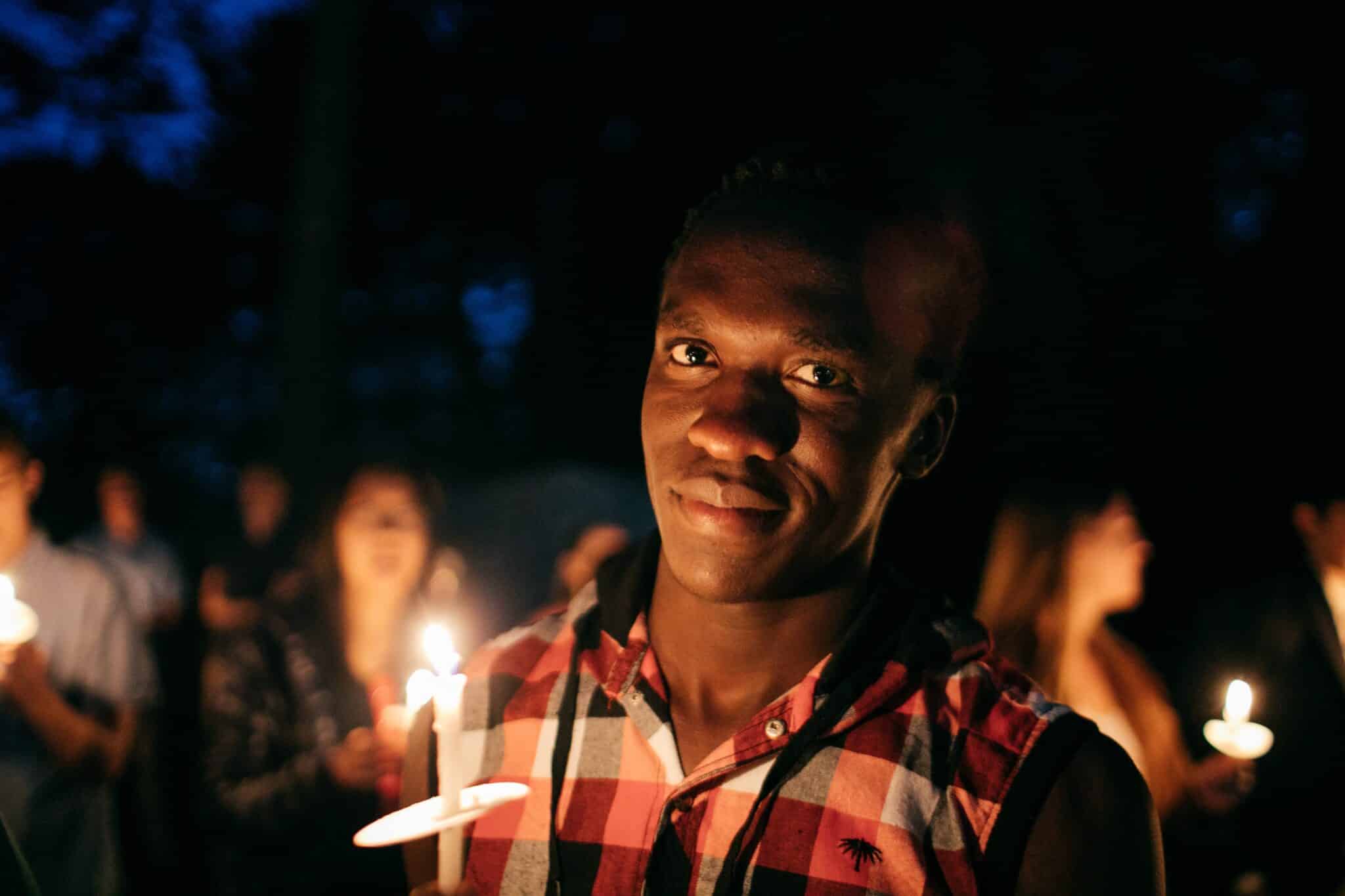 Man holding a candle | Photo by Nyabuto Onkundi on Unsplash