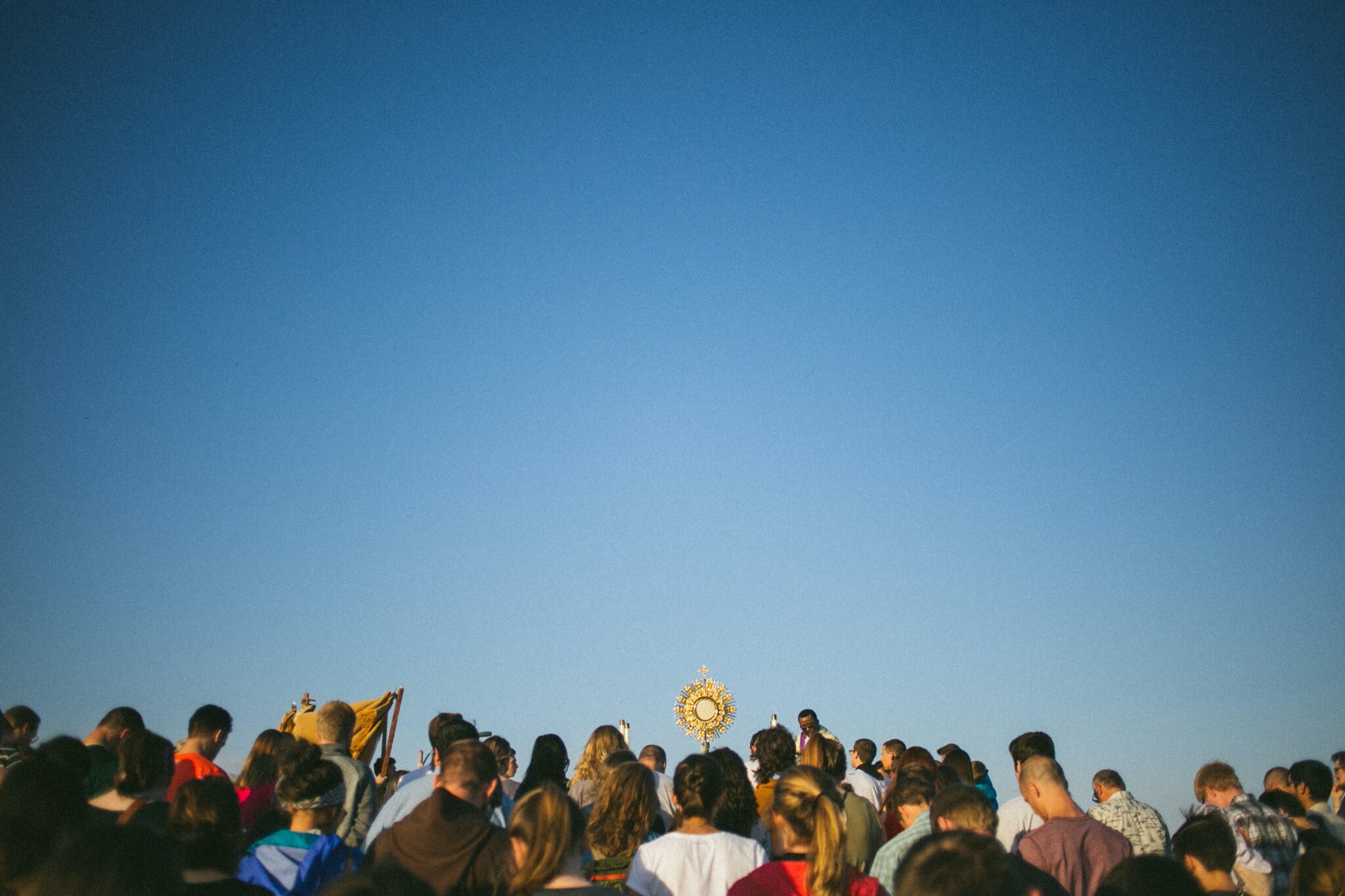 people celebrate mass outside | Photo by Rachel Moore on Unsplash