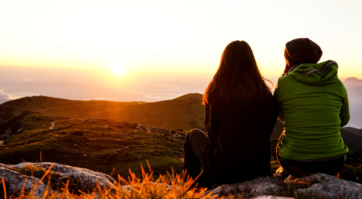 two women looking at sunrise