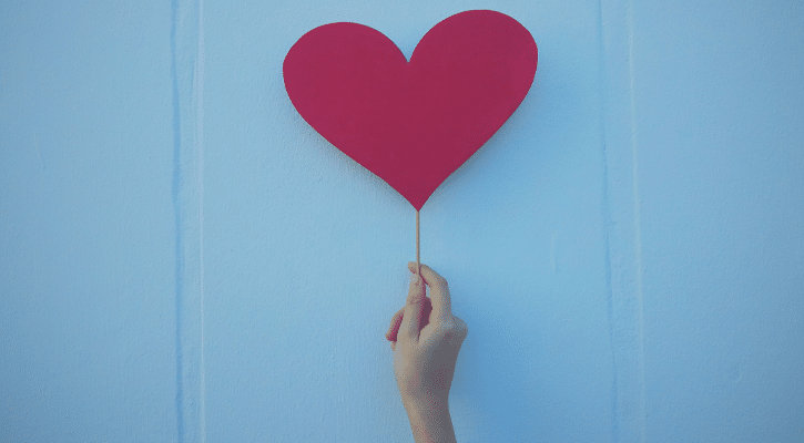 hand holing up a heart cutout