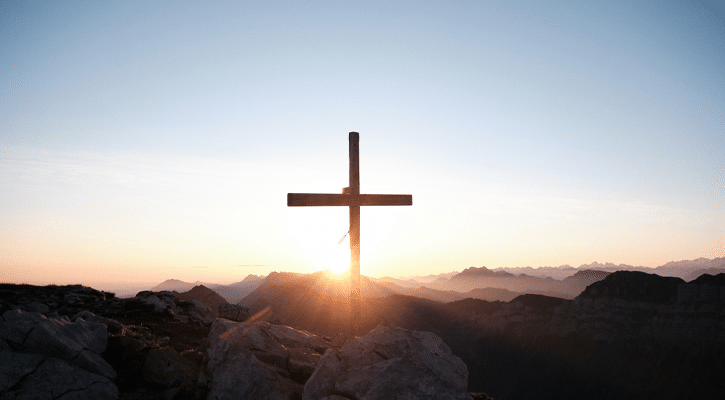 wood cross on rocky landscape