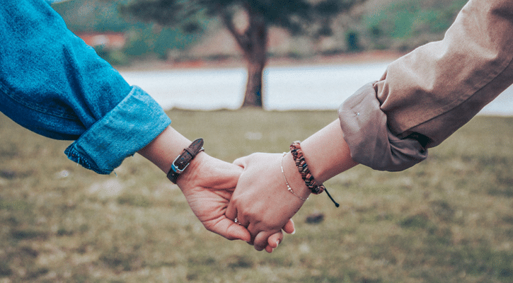 two women holding hands