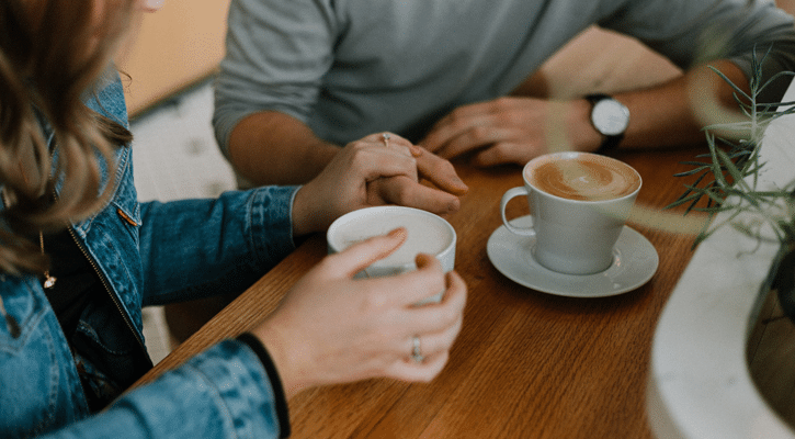 two people with coffee cups