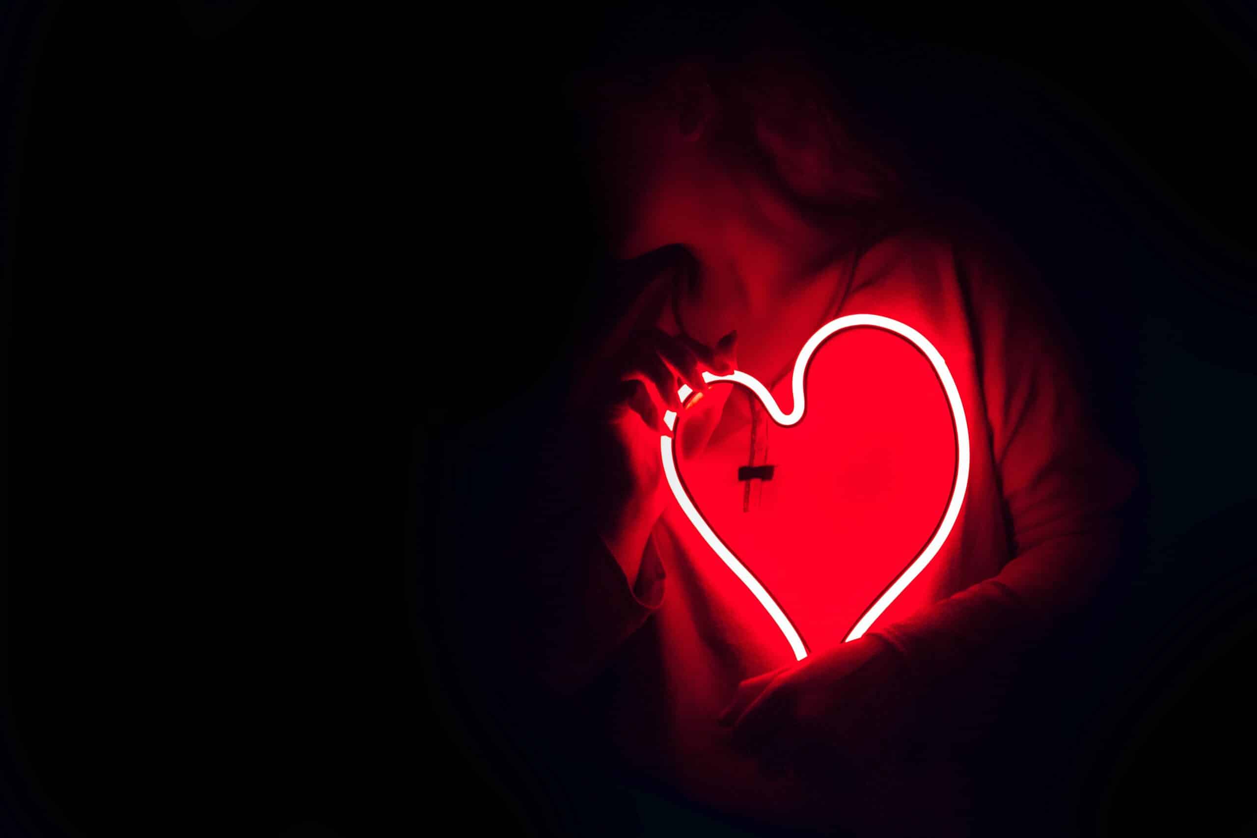 woman holding a heart | Photo by DESIGNECOLOGIST on Unsplash
