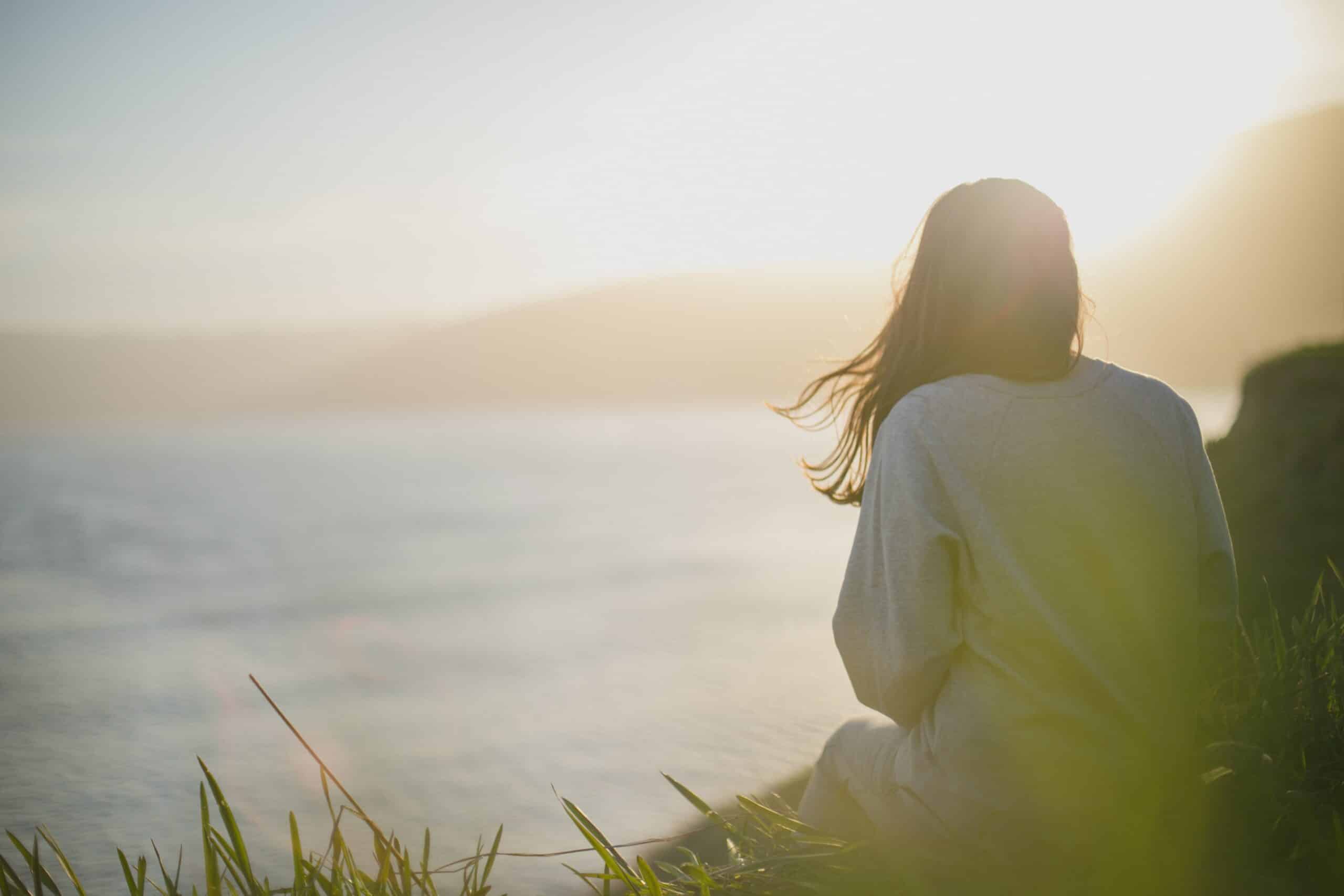 Woman sitting alone on a bluff